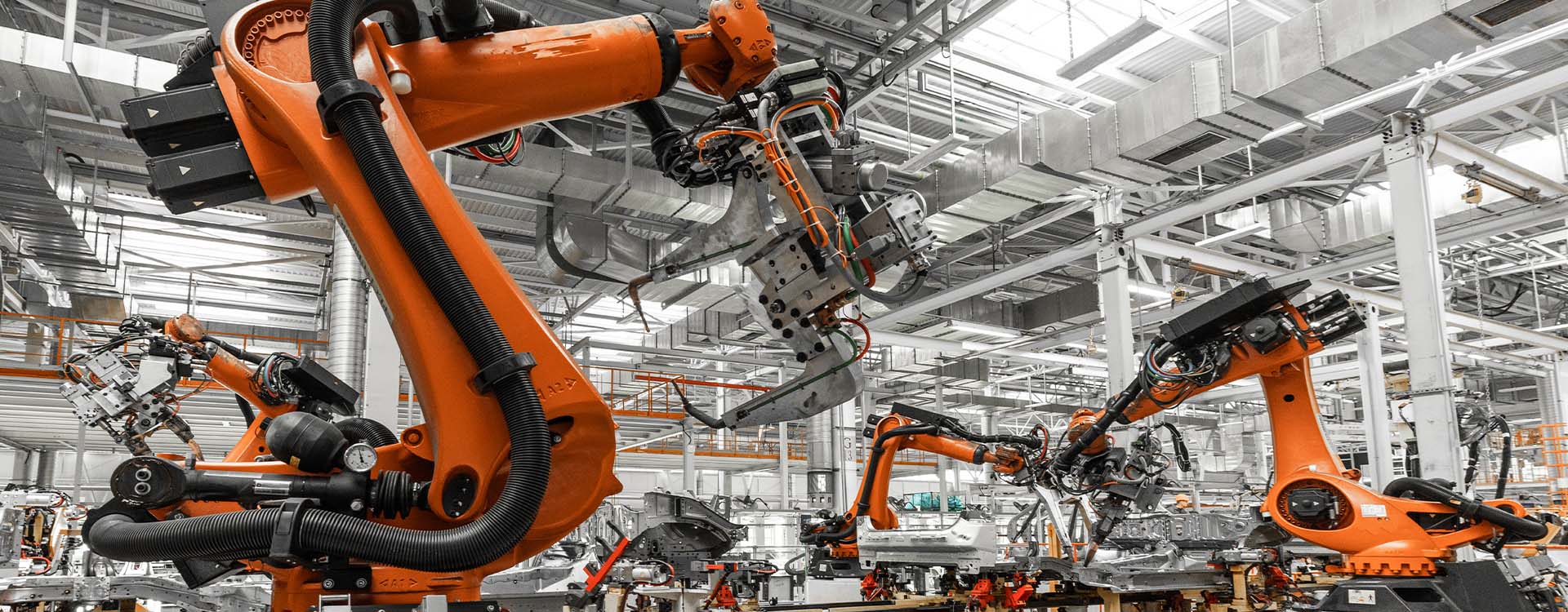 Robotic arms working on an industrial manufacturing line